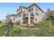 View of the back of this home and yard, featuring a grassy lawn and a deck at 3109 Newport Cir, Castle Rock, CO 80104