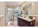 Bathroom featuring dual sinks, granite countertops, tile flooring, and ensuite access at 3109 Newport Cir, Castle Rock, CO 80104