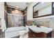 This bathroom showcases decorative tiling in the shower and behind the sink, with a large mirror accenting the space at 3109 Newport Cir, Castle Rock, CO 80104