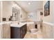 Luxurious bathroom featuring a soaking tub, tiled walls, and a vanity with ample counter space at 3109 Newport Cir, Castle Rock, CO 80104
