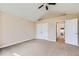 A well-lit bedroom featuring neutral walls, carpet floors, and a ceiling fan, complemented by a closet and doorway at 3109 Newport Cir, Castle Rock, CO 80104