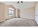 Bedroom with vaulted ceiling, ceiling fan, large window, and neutral-toned walls at 3109 Newport Cir, Castle Rock, CO 80104