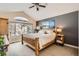 Primary bedroom with wooden bed frame, sitting area, and large windows at 3109 Newport Cir, Castle Rock, CO 80104