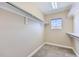 Walk-in closet with carpet floor, shelves, and a small window for natural light at 3109 Newport Cir, Castle Rock, CO 80104
