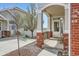 Inviting front porch with brick accents and scenic views creates a warm welcome at 3109 Newport Cir, Castle Rock, CO 80104
