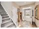 Welcoming foyer features a staircase, tiled floor, and an abundance of natural light at 3109 Newport Cir, Castle Rock, CO 80104
