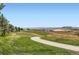 Scenic golf course view showcasing green fairways, natural landscaping, and distant mountain views at 3109 Newport Cir, Castle Rock, CO 80104