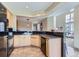 Open kitchen design with wood cabinets, granite countertops, black appliances, and a breakfast bar at 3109 Newport Cir, Castle Rock, CO 80104