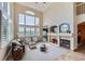 Bright living room with high ceilings, large windows, fireplace, and an open floor plan at 3109 Newport Cir, Castle Rock, CO 80104