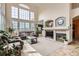 Elegant living room boasts a fireplace and large windows, offering plenty of natural light at 3109 Newport Cir, Castle Rock, CO 80104