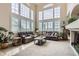 Bright living room featuring soaring ceilings and large windows with plantation shutters at 3109 Newport Cir, Castle Rock, CO 80104