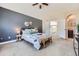 Inviting main bedroom with grey accent wall, ceiling fan, and ensuite bathroom access at 3109 Newport Cir, Castle Rock, CO 80104