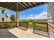 Covered patio with wood railing, grassy area, and amazing views of mountains and the surrounding landscape at 3109 Newport Cir, Castle Rock, CO 80104