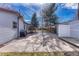 A sprawling stone patio enhances this backyard, complete with a shed, grill, and basketball hoop for outdoor fun at 6719 Quay St, Arvada, CO 80003