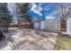 Spacious backyard featuring a charming shed, white lattice screen, and a stone-tiled patio, ideal for outdoor entertaining at 6719 Quay St, Arvada, CO 80003