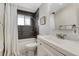 Modern bathroom with sleek gray tiled shower and white vanity at 6719 Quay St, Arvada, CO 80003