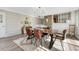 Sunlit dining room with modern chandelier, a wood table, and stylish chairs on a patterned rug at 6719 Quay St, Arvada, CO 80003