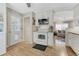 Well-lit kitchen with white appliances and a door leading to another room at 6719 Quay St, Arvada, CO 80003