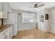 Bright kitchen featuring white cabinets, neutral countertops, and a ceiling fan at 6719 Quay St, Arvada, CO 80003