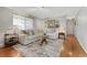 Bright living room with hardwood floors, a neutral sofa, and decorative rug at 6719 Quay St, Arvada, CO 80003