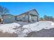 House with backyard patio, shed, and snowy ground at 7301 E 82Nd Pl, Commerce City, CO 80022