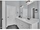 Double vanity bathroom with modern finishes and a large mirror at 7301 E 82Nd Pl, Commerce City, CO 80022