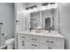 Modern double vanity bathroom with black matte hardware and a large mirror at 7301 E 82Nd Pl, Commerce City, CO 80022