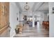 Bright entryway with wood floors, bench, and views to living room at 7301 E 82Nd Pl, Commerce City, CO 80022