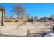 Large front yard with circular driveway and landscaping at 7301 E 82Nd Pl, Commerce City, CO 80022