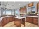 L-shaped kitchen with island and stainless steel appliances at 7301 E 82Nd Pl, Commerce City, CO 80022