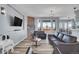 Living room with fireplace, hardwood floors, and large windows at 7301 E 82Nd Pl, Commerce City, CO 80022