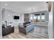 Living room with fireplace, large windows, and hardwood floors at 7301 E 82Nd Pl, Commerce City, CO 80022