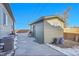 Green shed and side yard with concrete patio and AC unit at 7301 E 82Nd Pl, Commerce City, CO 80022