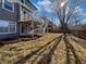 Backyard featuring wood deck with stairs, fence, and garden plots at 1682 Mountain Maple Ave, Highlands Ranch, CO 80129