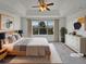 Staged main bedroom with tray ceiling, ceiling fan and views at 1682 Mountain Maple Ave, Highlands Ranch, CO 80129