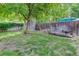 This backyard features a storage shed and sitting area and a tree for shade at 4301 Zuni St, Denver, CO 80211
