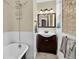 This renovated bathroom features stylish fixtures, exposed brick, and a soaking tub at 4301 Zuni St, Denver, CO 80211