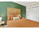 Cozy bedroom features a statement headboard, fresh green walls and bright neutral trim at 4301 Zuni St, Denver, CO 80211