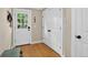 Bright entryway featuring a wooden floor, white door, and a convenient closet at 4301 Zuni St, Denver, CO 80211