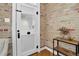 Welcoming foyer with a rustic door, exposed brick wall, and decorative wooden shelf at 4301 Zuni St, Denver, CO 80211