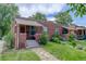 Charming brick home with a well-maintained lawn and a red front door and stone walkway at 4301 Zuni St, Denver, CO 80211