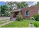 Charming single-story brick home featuring a cozy front porch and manicured lawn at 4301 Zuni St, Denver, CO 80211
