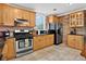 Well-lit kitchen with stainless steel appliances, wooden cabinets, and eye-catching brick accents at 4301 Zuni St, Denver, CO 80211