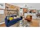 Bright living room boasts exposed brick wall, plush seating, and open flow to the kitchen at 4301 Zuni St, Denver, CO 80211