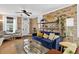 Inviting living room featuring exposed brick, a comfortable blue sofa, and stylish decor at 4301 Zuni St, Denver, CO 80211