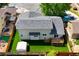 Aerial view of a home's backyard featuring a deck, lush lawn, and storage shed at 1545 August Ln, Brighton, CO 80601