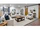 Finished basement with barn doors, stylish seating, and ample natural light at 1545 August Ln, Brighton, CO 80601