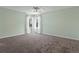 Spacious bedroom with plush carpeting and corner windows at 1545 August Ln, Brighton, CO 80601
