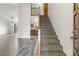 Inviting foyer with hardwood floors and a staircase leading to the upper level at 1545 August Ln, Brighton, CO 80601