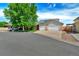 Charming home exterior with a well-manicured lawn, mature trees, and a wide driveway at 1545 August Ln, Brighton, CO 80601